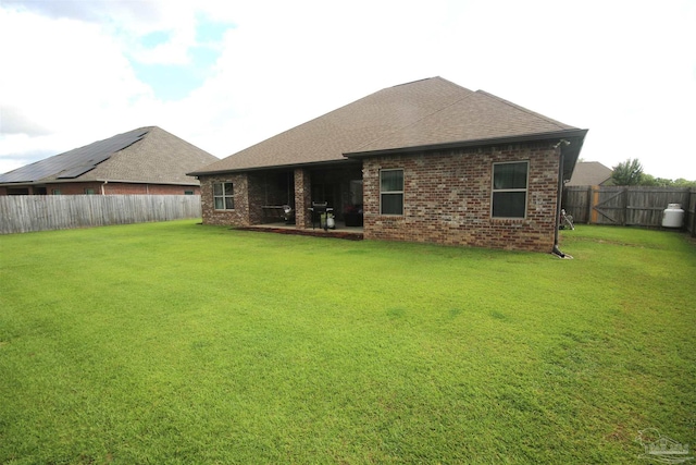 4135 Dundee Crossing Dr, Pace, FL 32571 - back of house with brick siding and roof with shingles