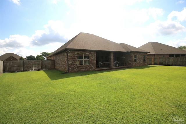 4135 Dundee Crossing Dr, Pace, FL 32571 - rear view of house featuring brick siding and roof with shingles