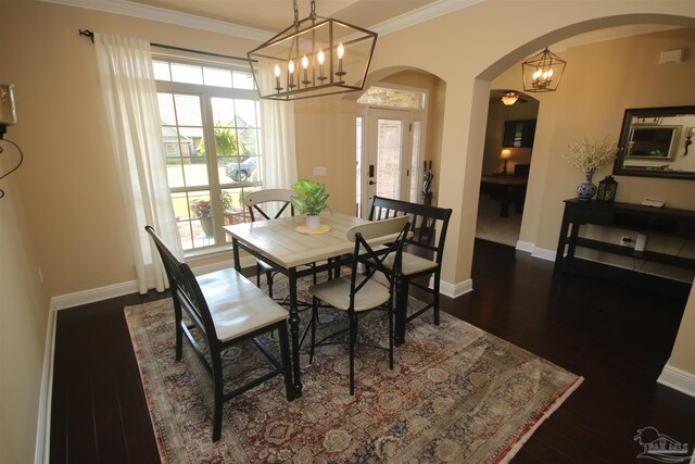 4135 Dundee Crossing Dr, Pace, FL 32571 - dining area featuring arched walkways, a chandelier, plenty of natural light, ornamental molding, and baseboards