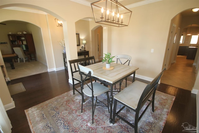 4135 Dundee Crossing Dr, Pace, FL 32571 - dining area with arched walkways, a chandelier, wood finished floors, and ornamental molding