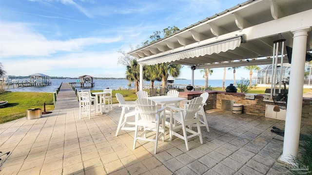 view of patio featuring area for grilling, outdoor dining area, a water view, and a boat dock