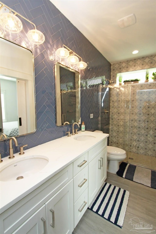 bathroom with hardwood / wood-style floors, vanity, and tile walls