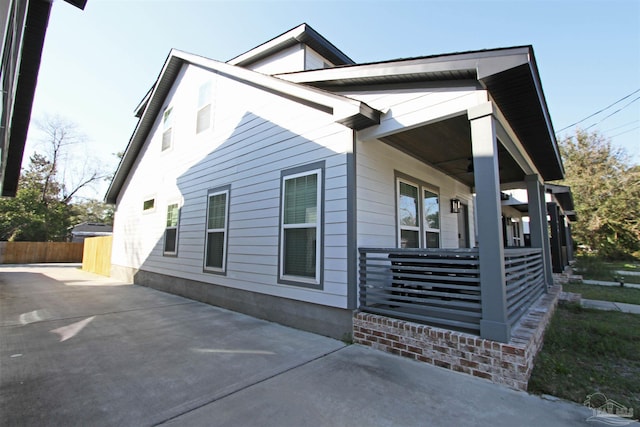 view of property exterior with a porch