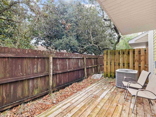 wooden terrace featuring central AC unit and fence