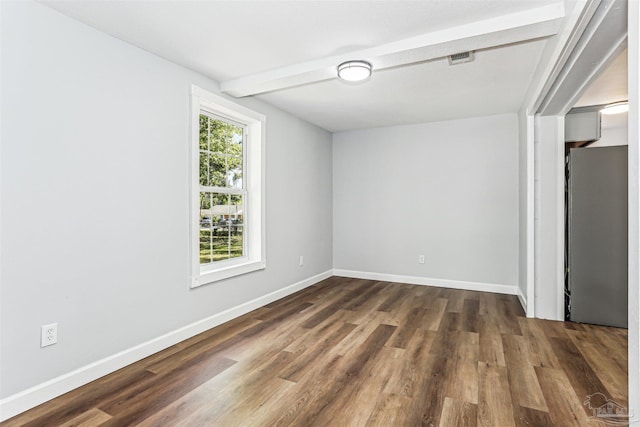 808 Woodland Dr, Pensacola, FL 32503 - empty room featuring baseboards, dark wood-style flooring, beam ceiling, and visible vents
