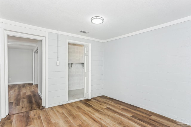 808 Woodland Dr, Pensacola, FL 32503 - unfurnished bedroom featuring wood finished floors, visible vents, and a closet