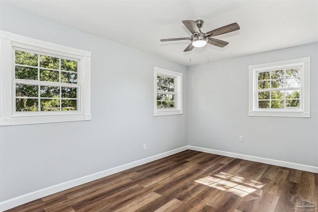 808 Woodland Dr, Pensacola, FL 32503 - unfurnished room featuring dark wood finished floors, a wealth of natural light, and baseboards