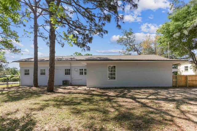808 Woodland Dr, Pensacola, FL 32503 - back of property with stucco siding, a yard, central air condition unit, and fence