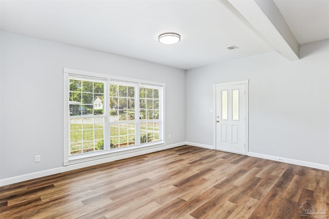 808 Woodland Dr, Pensacola, FL 32503 - spare room with beamed ceiling, wood finished floors, visible vents, and baseboards
