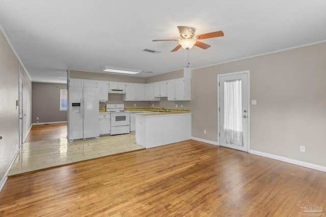 kitchen featuring light wood-type flooring, white appliances, a peninsula, and visible vents