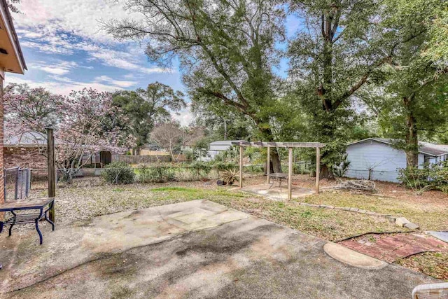 view of yard with a patio, fence, and a pergola