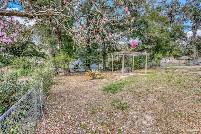 view of yard with a fenced backyard, a pergola, and a patio