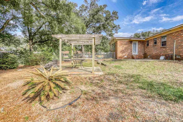 view of yard with fence and a pergola