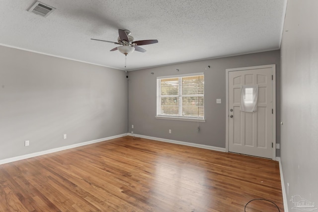 entryway with a ceiling fan, visible vents, light wood-style flooring, and baseboards