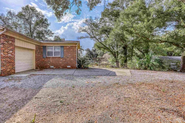 view of yard featuring a garage and fence