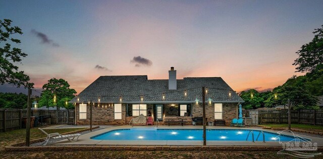 view of swimming pool with a fenced backyard and a patio