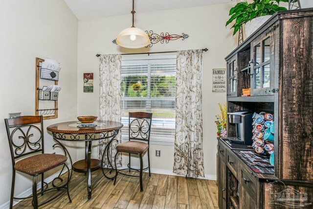 dining area with wood finished floors and baseboards