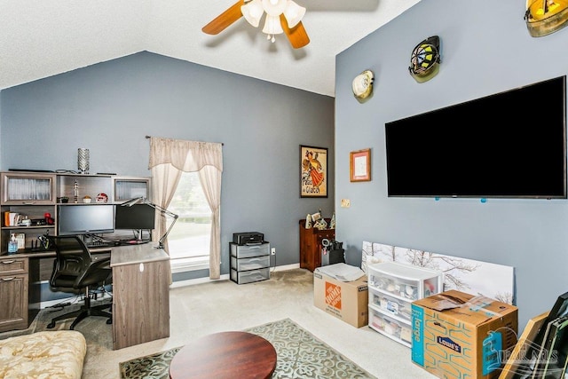 home office with lofted ceiling, ceiling fan, carpet, and baseboards