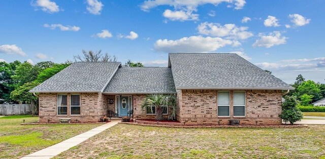 view of front of property with roof with shingles and brick siding