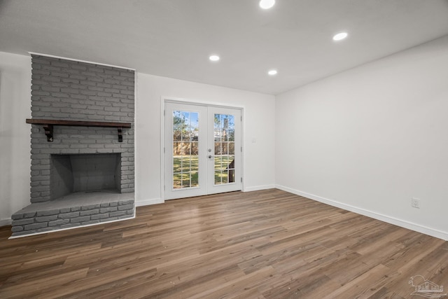 unfurnished living room with recessed lighting, french doors, baseboards, and wood finished floors