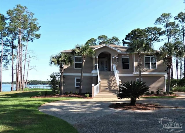 4564 Bayside Dr, Milton, FL 32583 - view of front of house with stairway, a water view, and a front yard