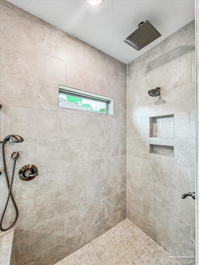 bathroom with tiled shower