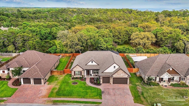 birds eye view of property featuring a view of trees