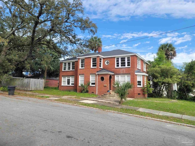 view of front of property featuring crawl space, brick siding, fence, and a chimney