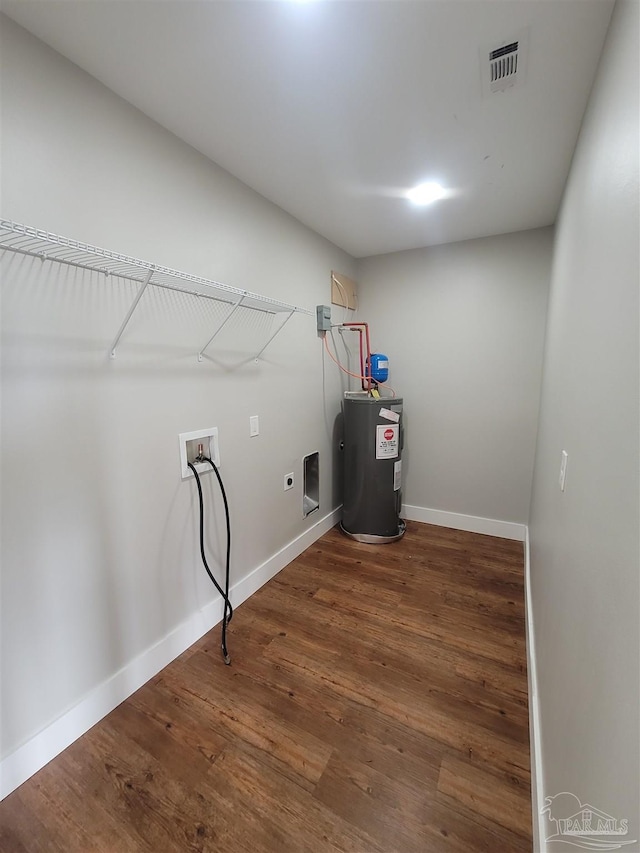 washroom with electric water heater, hookup for an electric dryer, wood-type flooring, and hookup for a washing machine