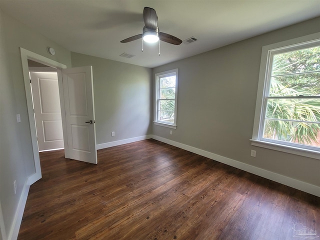 unfurnished room featuring dark hardwood / wood-style flooring and ceiling fan