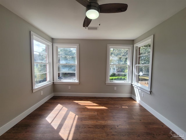 spare room featuring dark hardwood / wood-style floors and ceiling fan