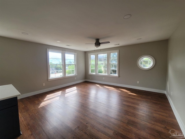 spare room featuring dark wood-type flooring and ceiling fan