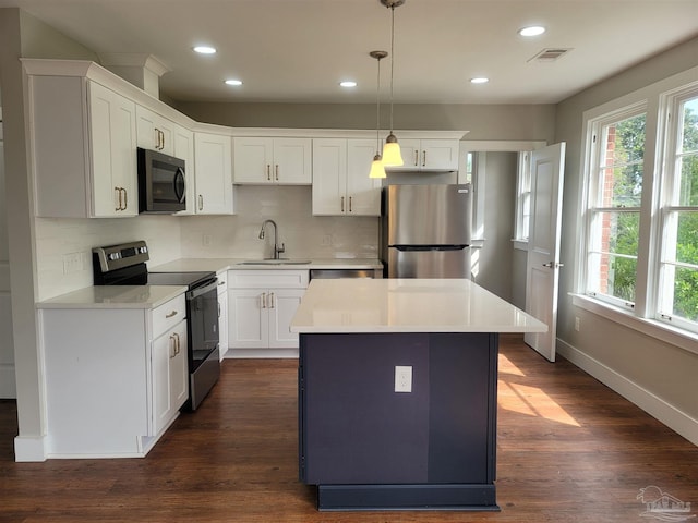 kitchen featuring white cabinetry, appliances with stainless steel finishes, dark hardwood / wood-style flooring, and tasteful backsplash