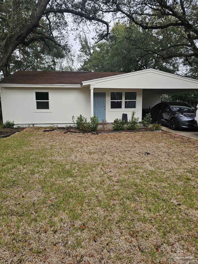 single story home featuring a carport and a front yard