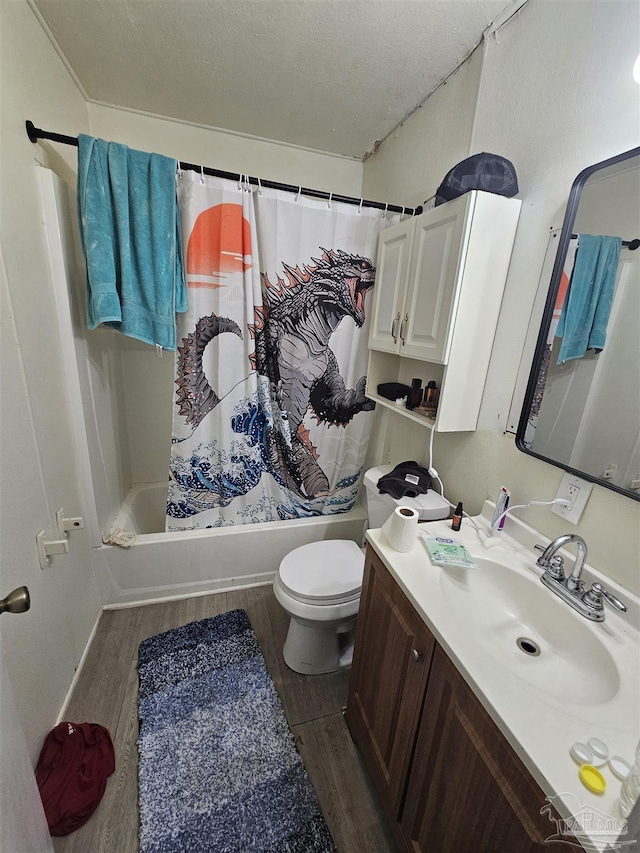 full bathroom featuring toilet, hardwood / wood-style floors, shower / bath combination with curtain, a textured ceiling, and vanity