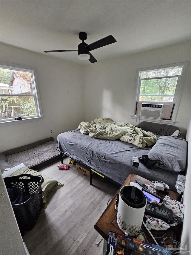 bedroom with ceiling fan and wood-type flooring