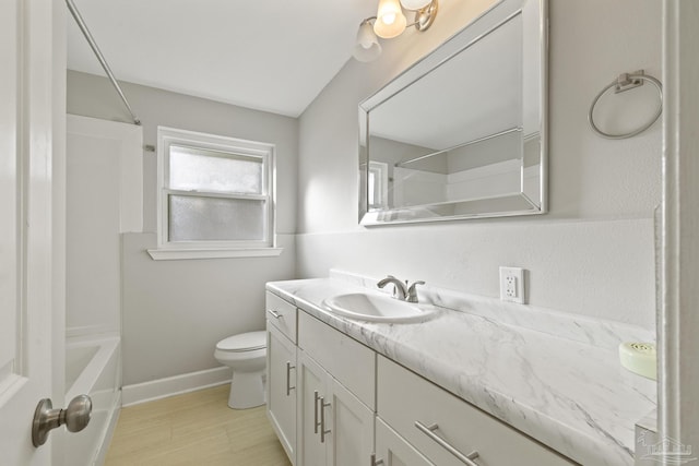 full bathroom with vanity, toilet, and washtub / shower combination