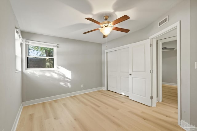 unfurnished bedroom featuring ceiling fan, light wood-type flooring, and a closet