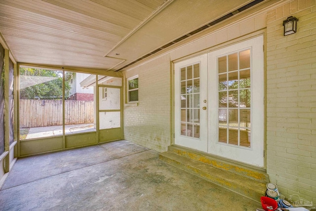 unfurnished sunroom featuring french doors and wood ceiling