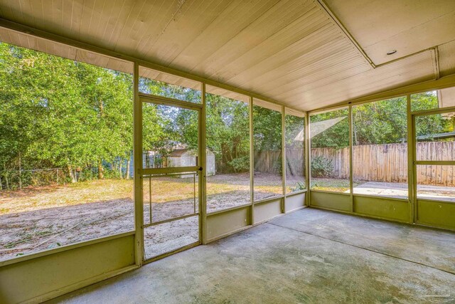 unfurnished sunroom with a healthy amount of sunlight and wood ceiling