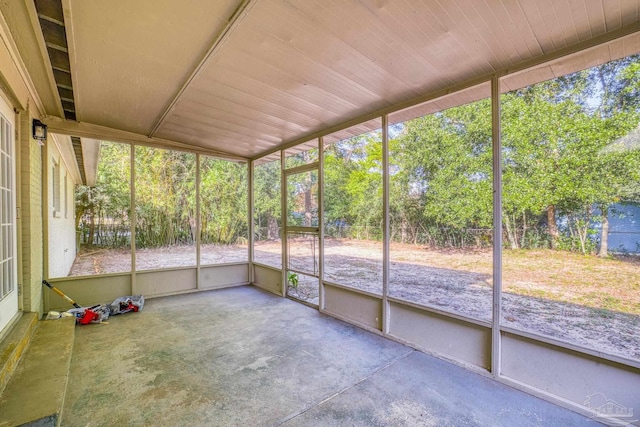 unfurnished sunroom with wood ceiling