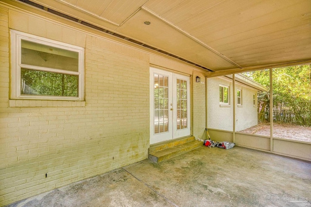 unfurnished sunroom with french doors