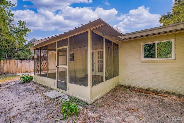 view of home's exterior with a sunroom