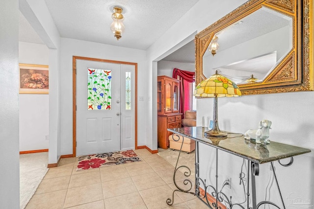 entryway featuring a textured ceiling and light tile patterned floors