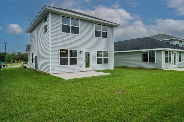 back of house featuring a patio and a lawn