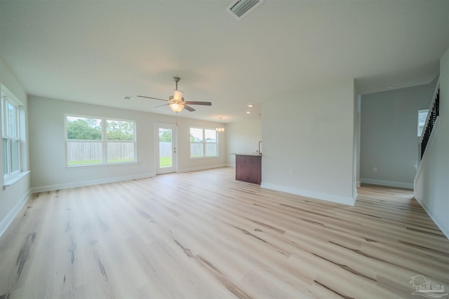 unfurnished living room featuring ceiling fan and light wood-type flooring