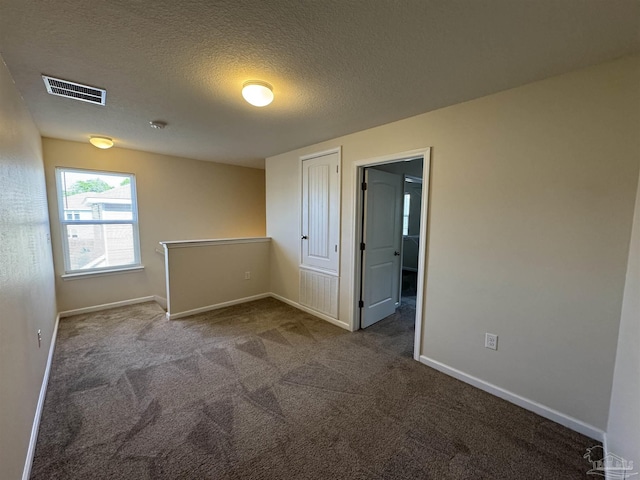 spare room with baseboards, carpet flooring, and visible vents