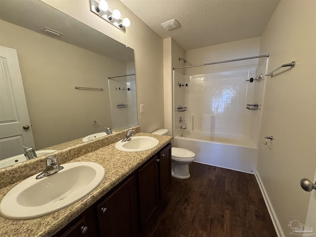 bathroom with toilet, a sink, and wood finished floors