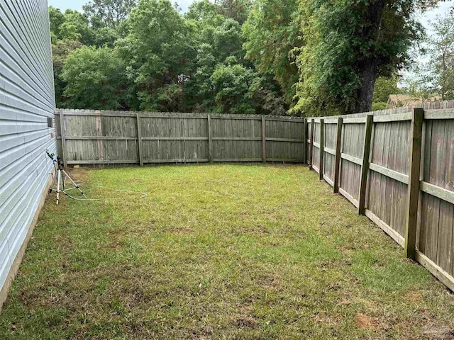 view of yard with a fenced backyard