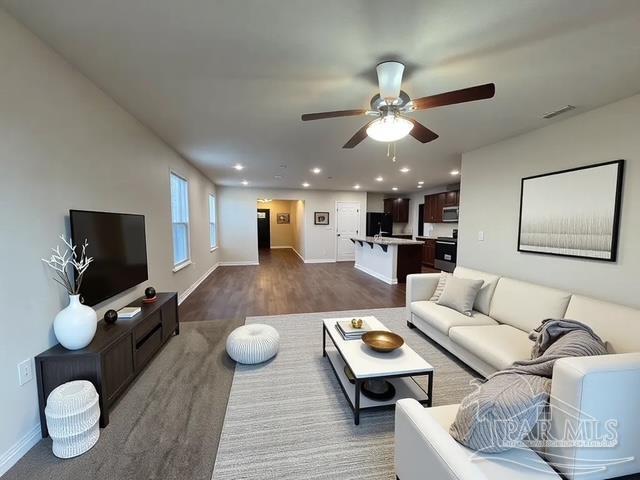 living room with baseboards, a ceiling fan, recessed lighting, and visible vents